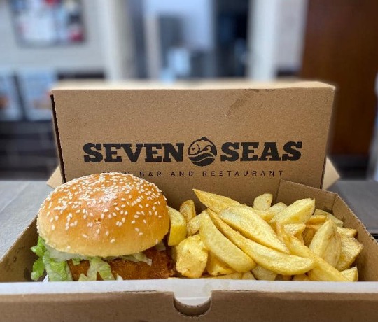 Burger and chips in a Seven Seas takeaway box